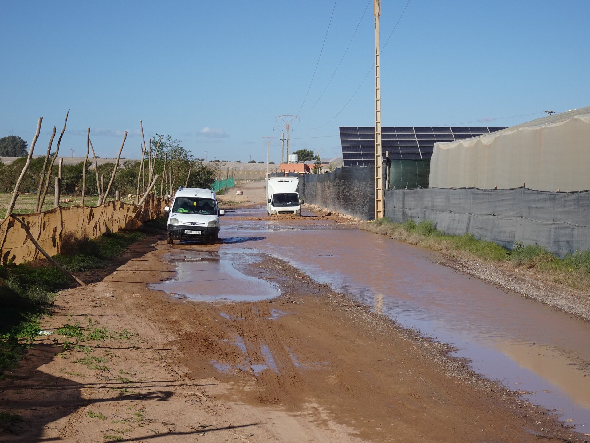Cars moving through puddles.