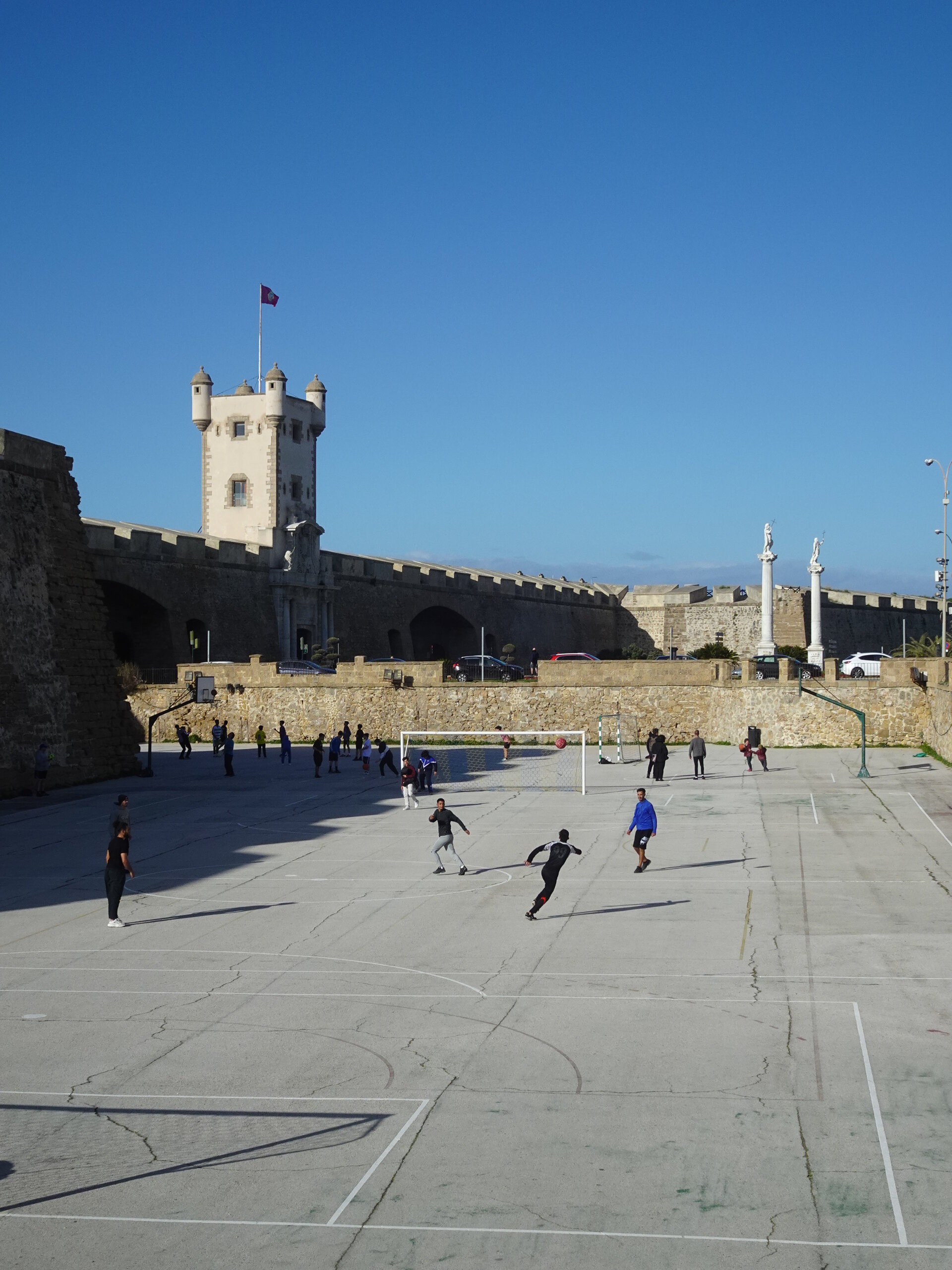Football match in front of a medieval fortress gate