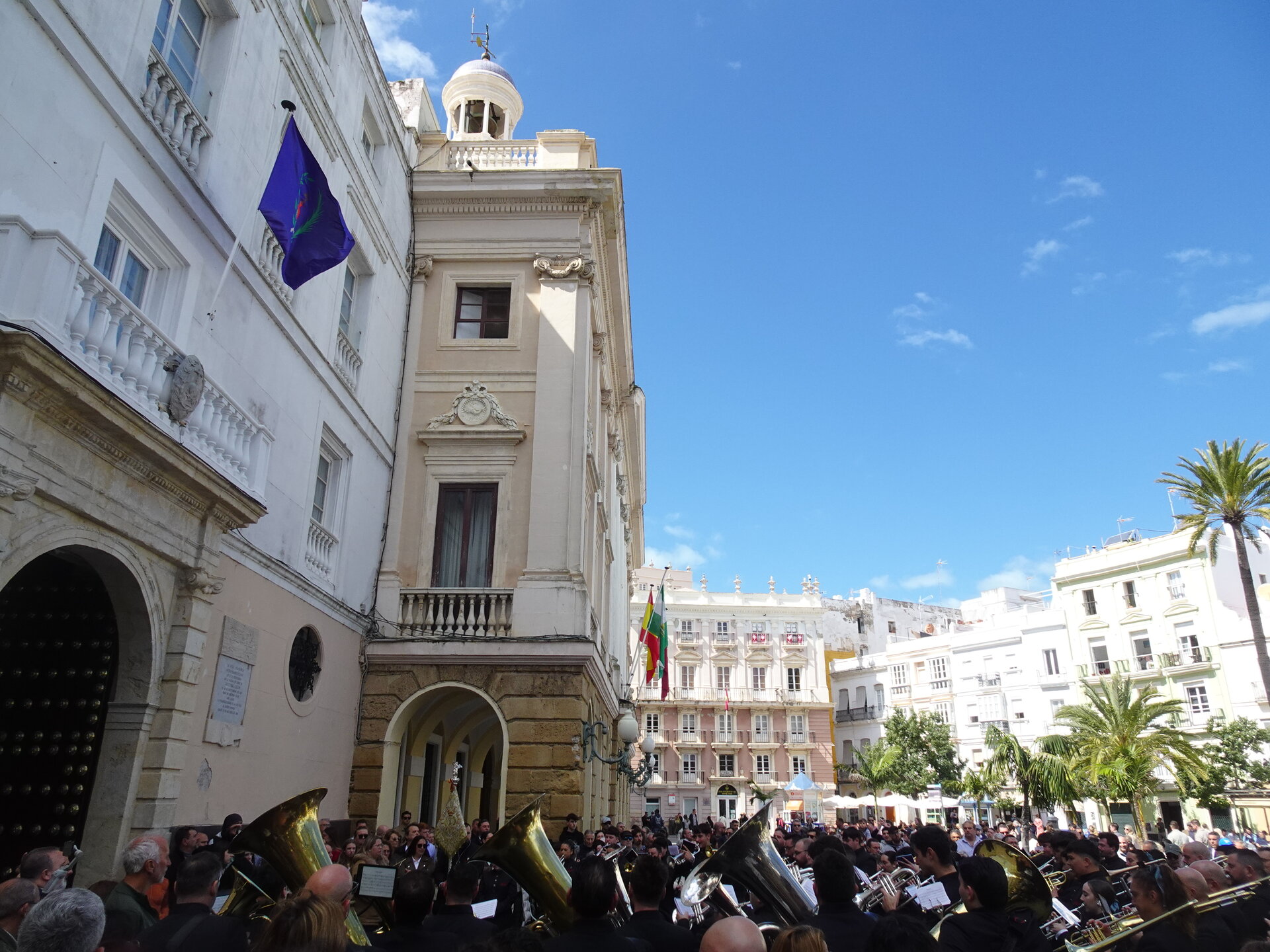 Brass band performing in a plaza with ornate buildings