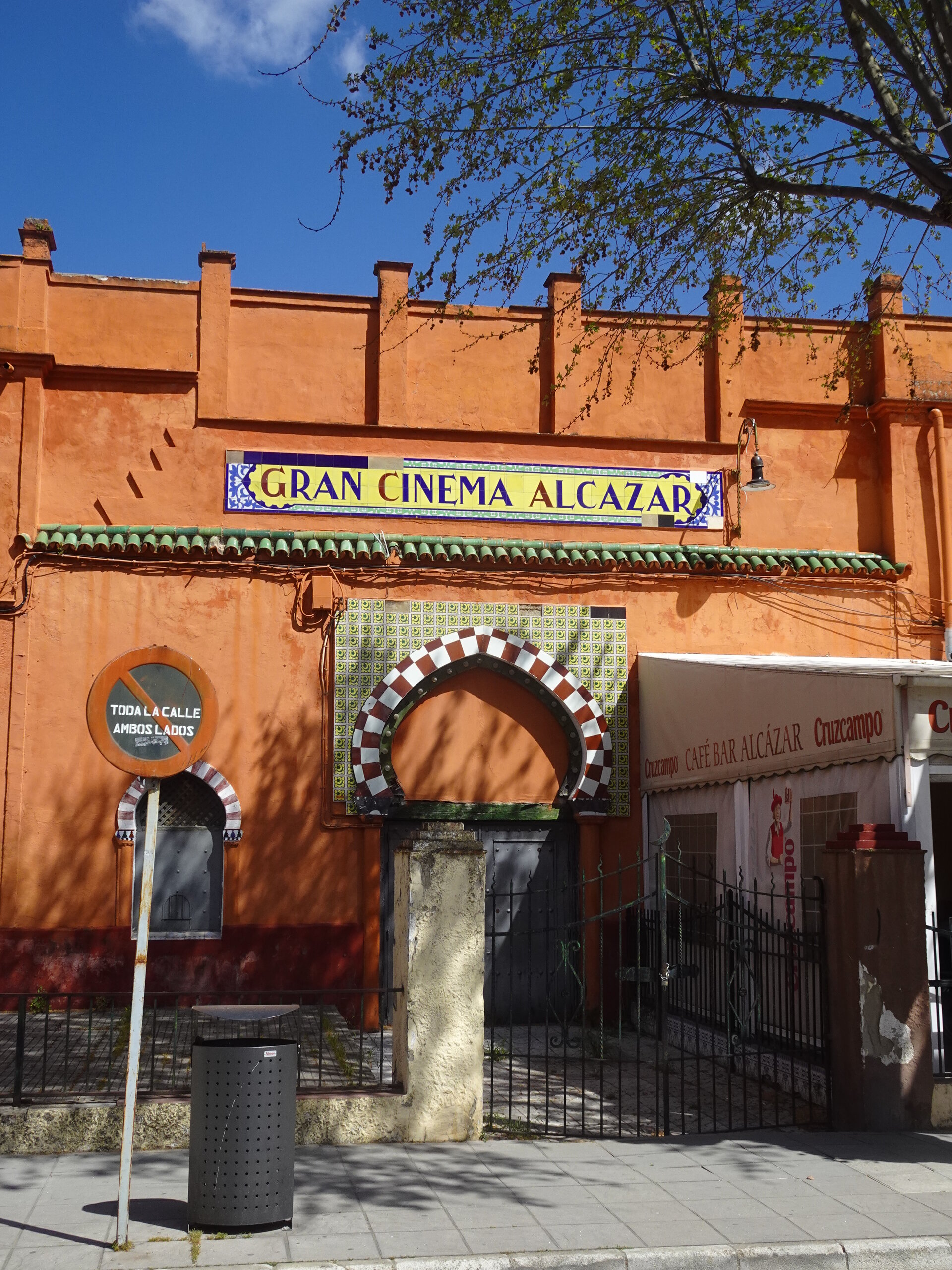 Orange Moorish cinema facade with tiled archway entrance