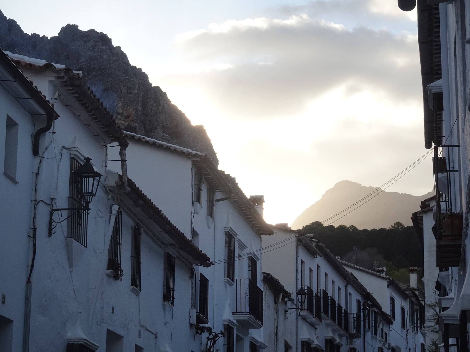 White houses beneath rocky cliffs at dusk