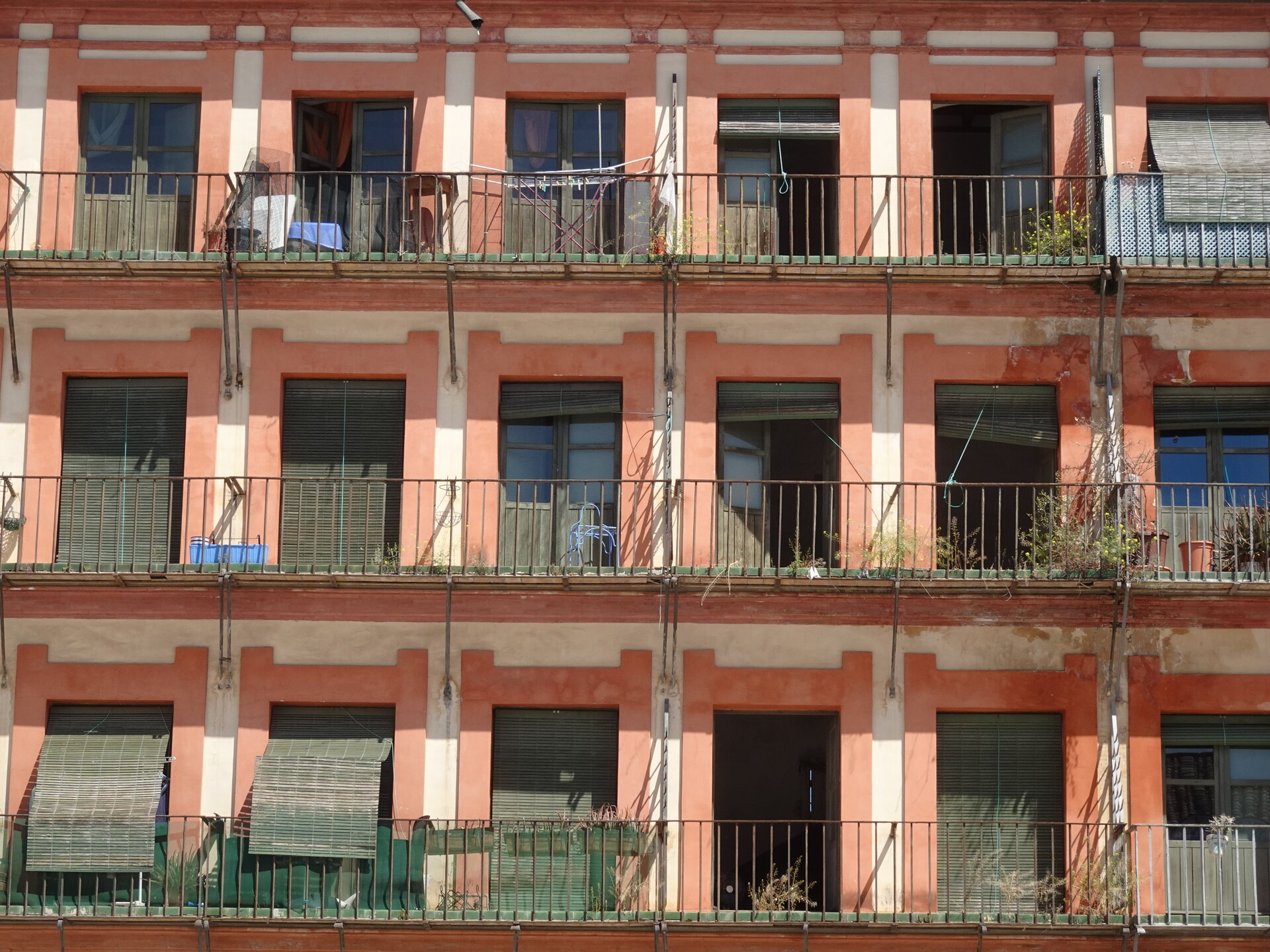 Repeating red and orange facade of stacked balconies in Plaza de la Corredera
