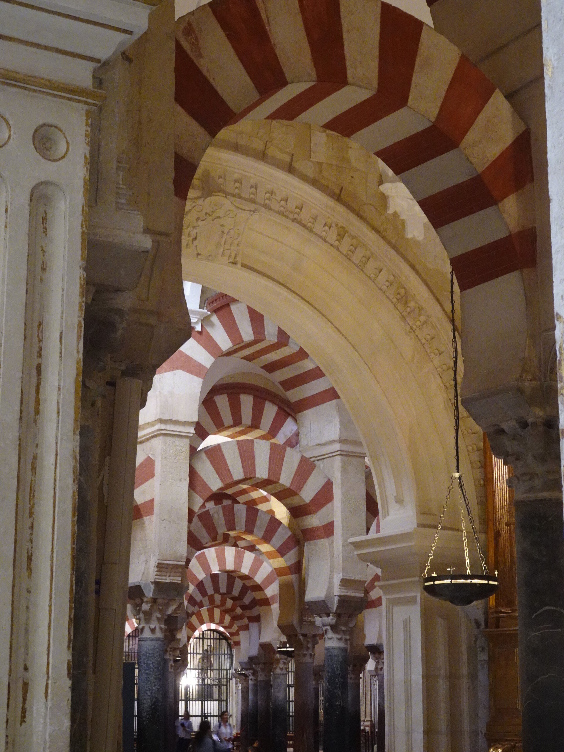 Iconic red and white striped horseshoe arches inside the Mezquita-Cathedral