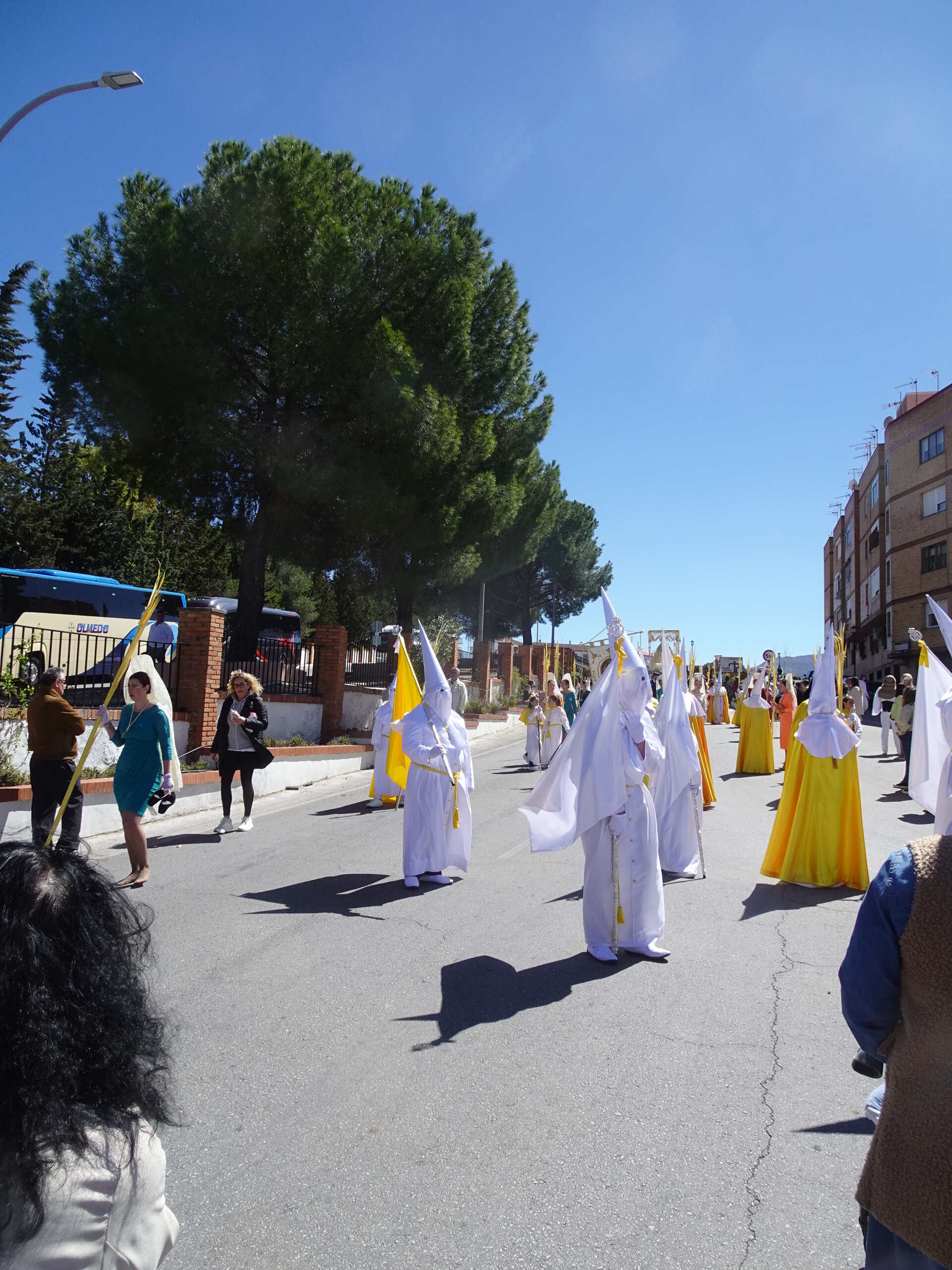 Semana Santa procession with hooded penitents in white robes