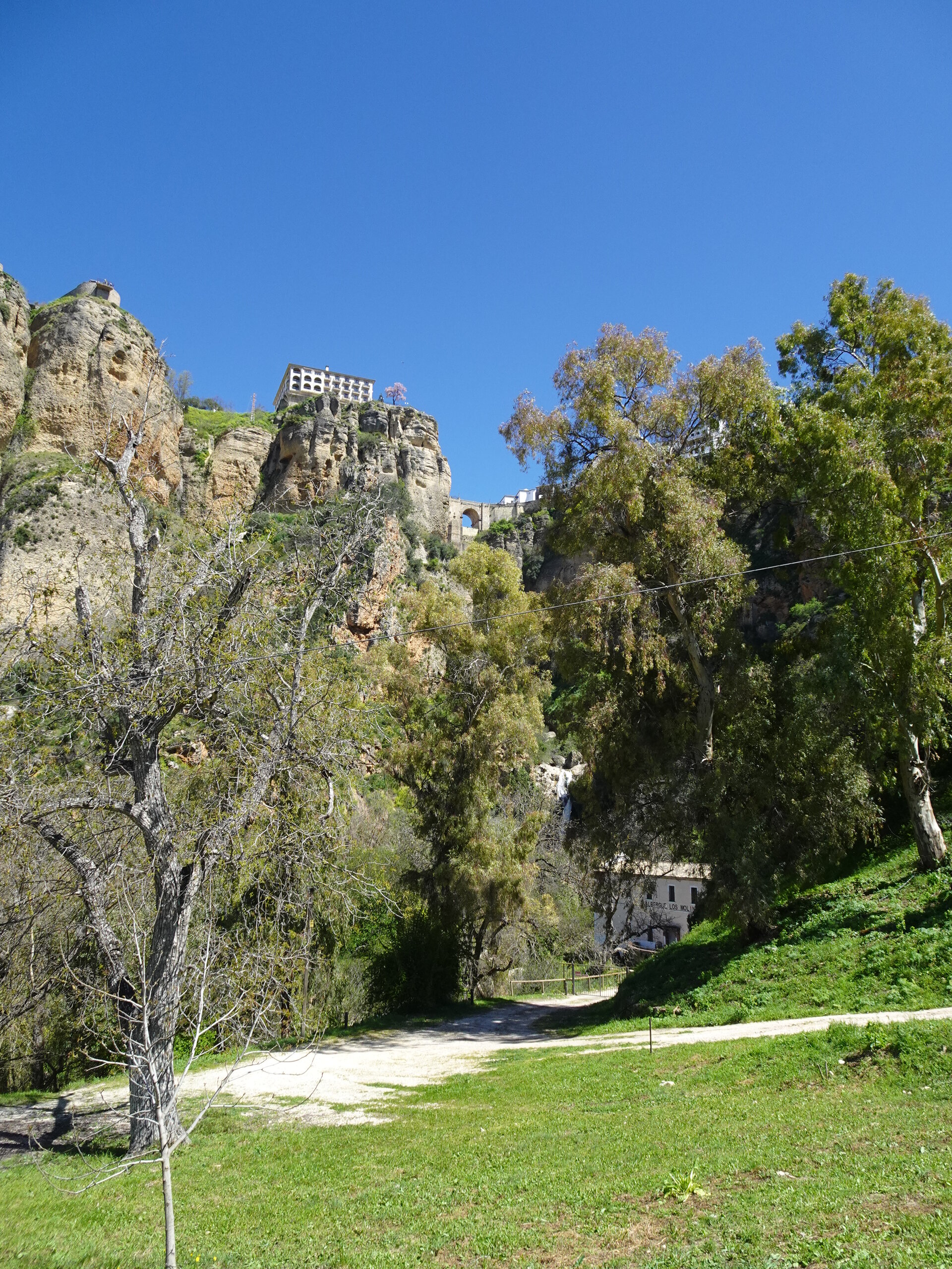 Ronda perched on cliffs seen from the gorge path below